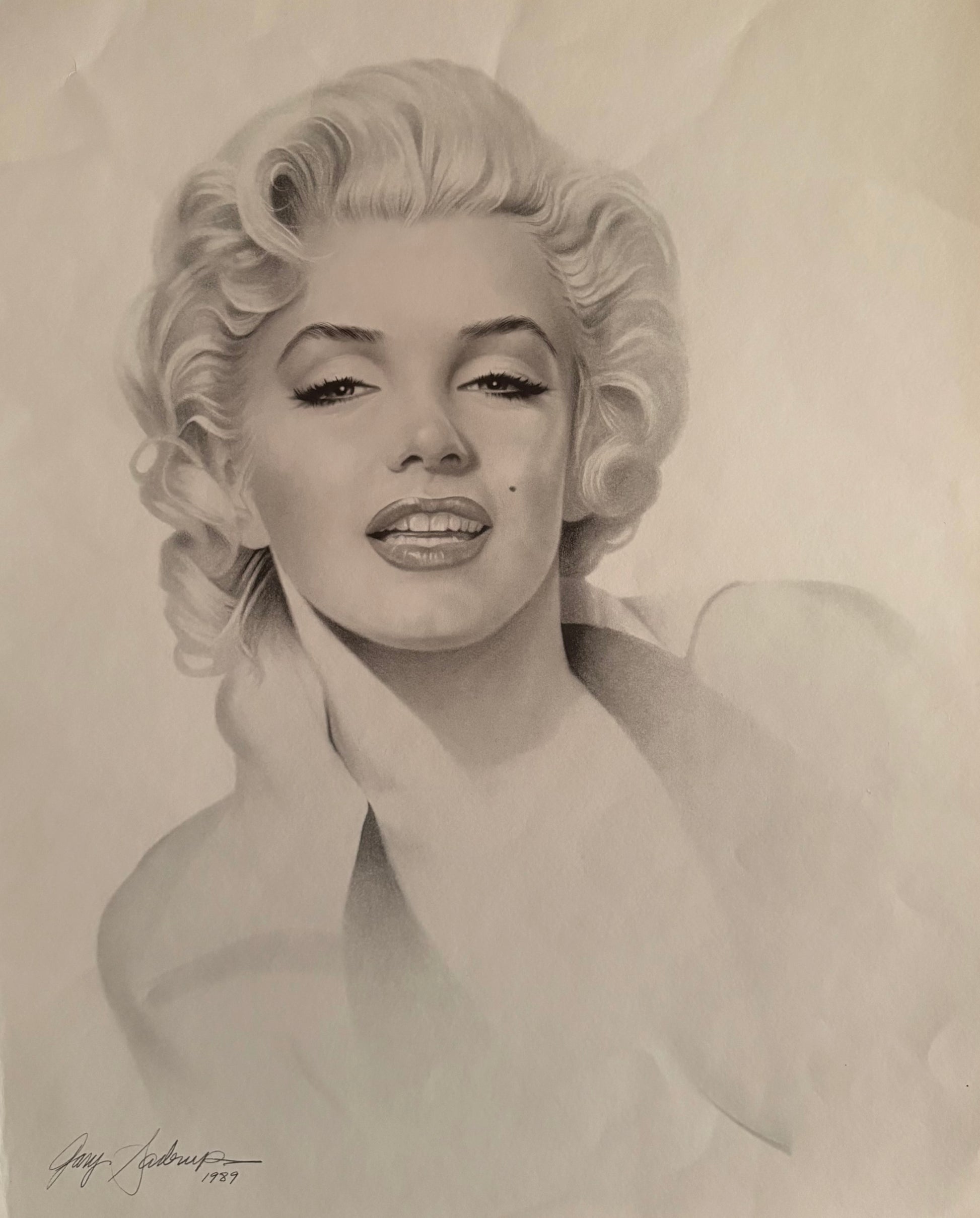 This image features a striking portrait of Marilyn Monroe, artistically rendered by Gary Saderup in 1989. The artwork, measuring 20 x 74 inches, captures Monroe's iconic features in a detailed black and white drawing.
